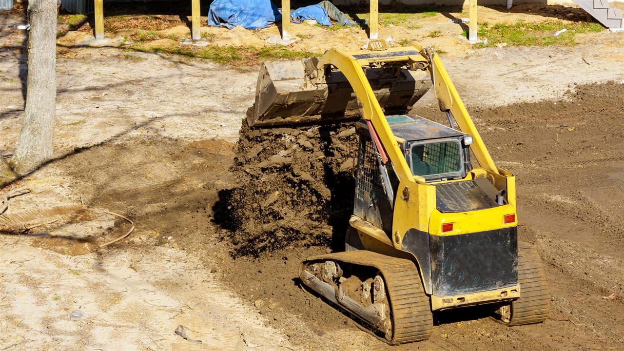 Compact track loader grading a landscaping site