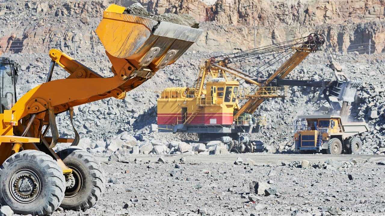 Mining excavator and haul truck in an open-pit quarry